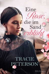 Eine Rose, die im Sand erblüht